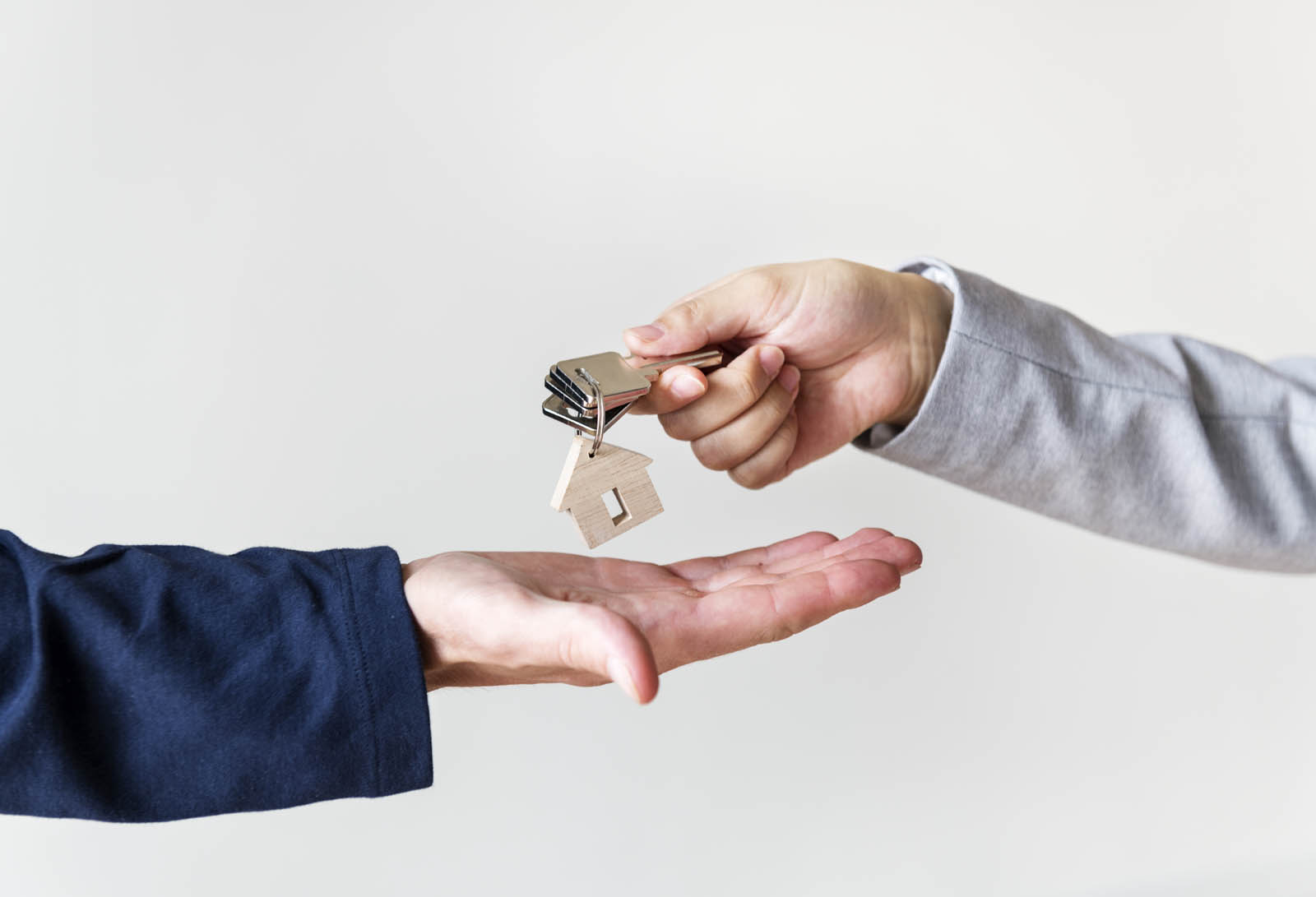 Landlord handing roomkey to tenant.